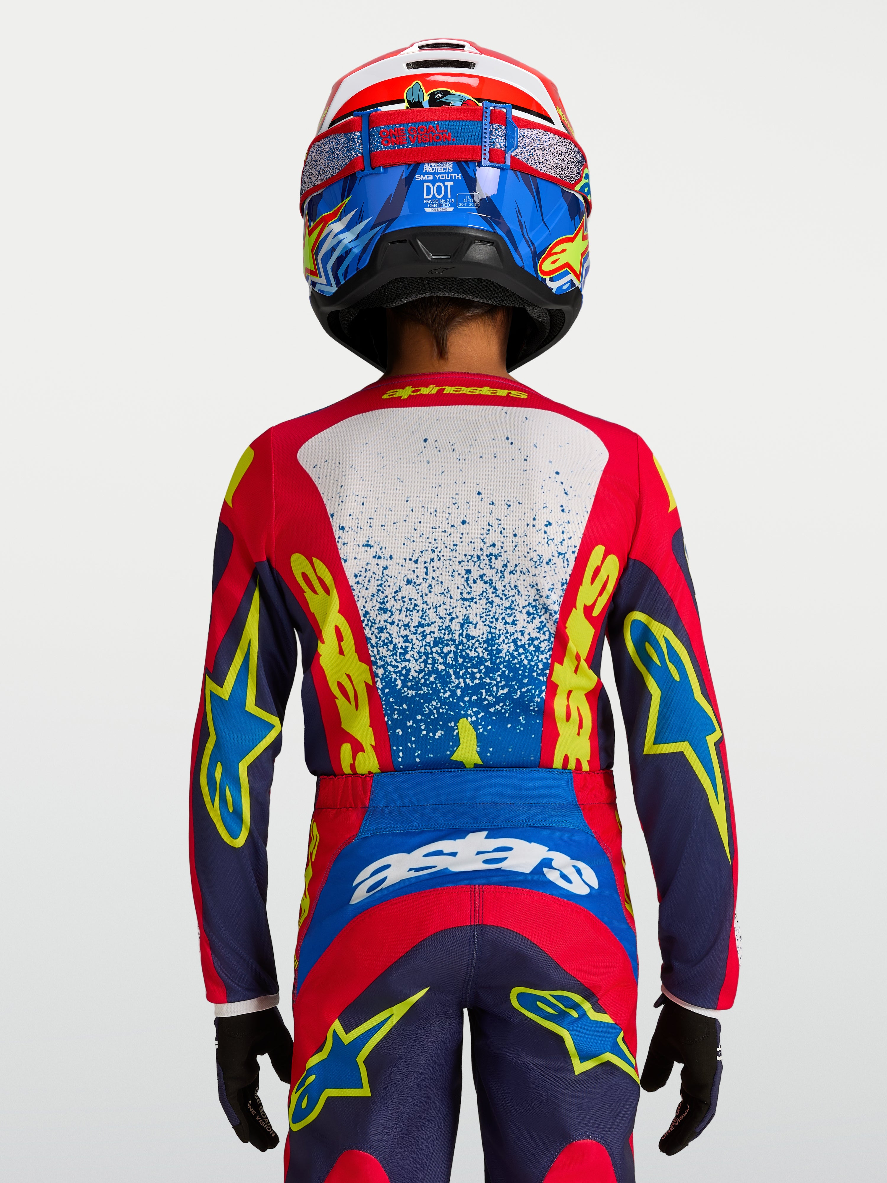 Alpinestars Camisola Fluid Drag Jovem 2027, camisola de motocross e todo-o-terreno para jovens, azul e vermelha, vista traseira de piloto com ajuste ergonómico.