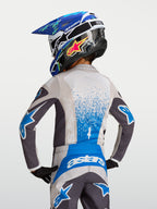 Alpinestars Camisola Fluid Drag Jovem 2027, para motocross, cinzenta e azul, vista traseira, tecido respirável.