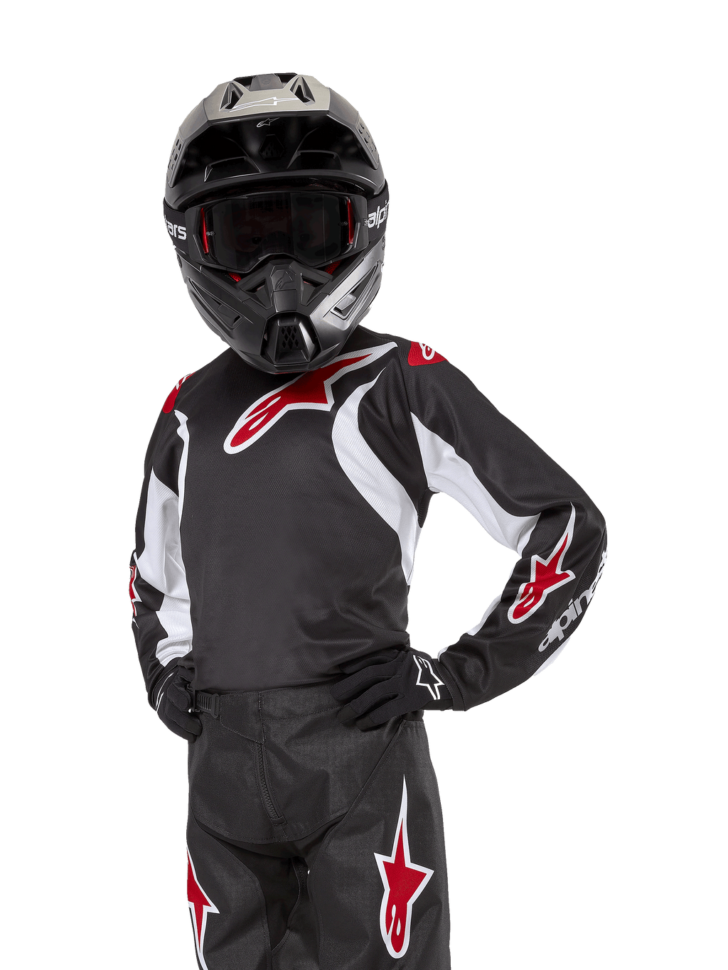 Camisola Racer Lucent Jovem 2024, camisola de motocross, preta, branca e vermelha, usada por um jovem piloto com capacete preto e calças a condizer, com logótipos de estrelas vermelhas e detalhes gráficos brancos, vestuário de performance para motocross e todo-o-terreno