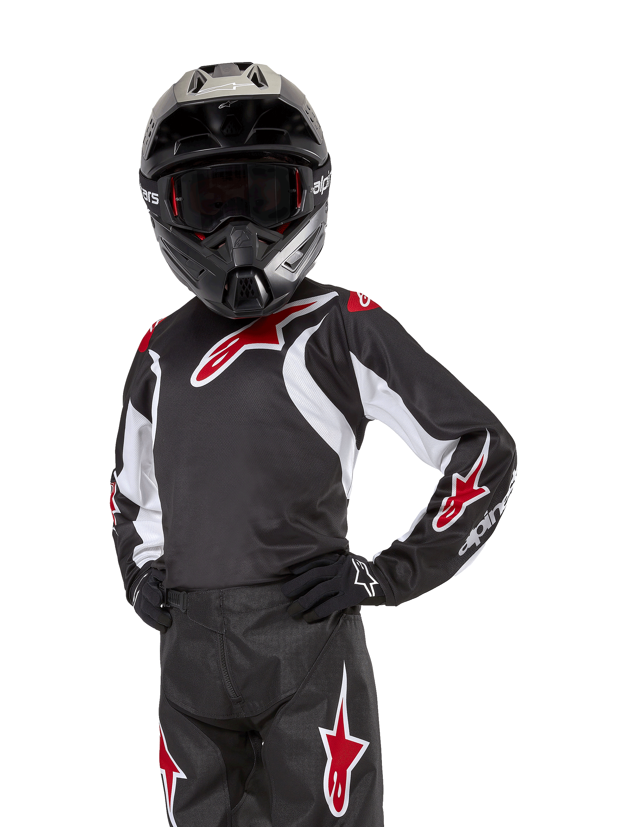 Camisola Racer Lucent Jovem 2024, camisola de motocross, preta, branca e vermelha, usada por um jovem piloto com capacete preto e calças a condizer, com logótipos de estrelas vermelhas e detalhes gráficos brancos, vestuário de performance para motocross e todo-o-terreno