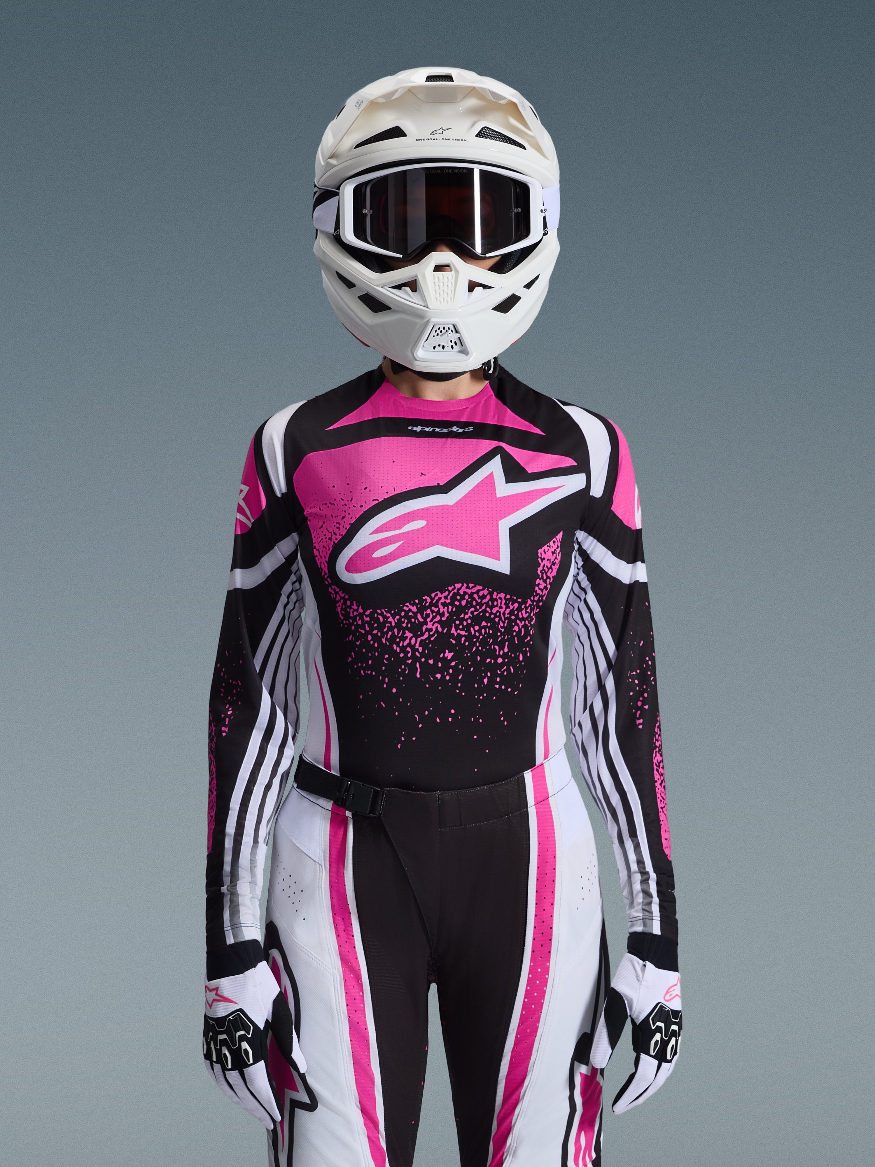 Alpinestars 2026 Stella Techstar Nomur Gear Set, Women's Motocross Outfit, Pink Black and White with large star logo, featuring matching jersey, pants, and gloves with a white helmet, front view on a grey background