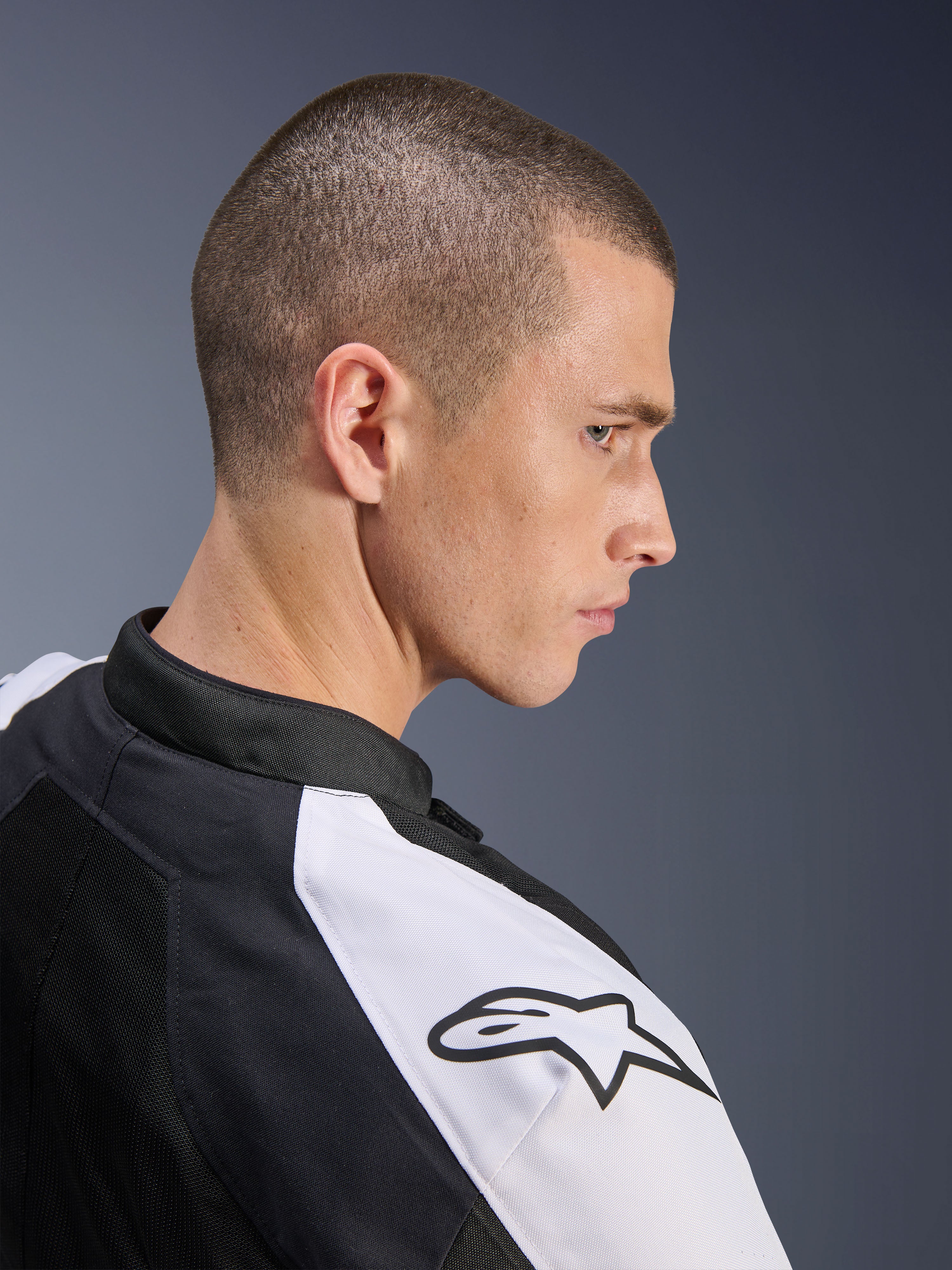 Alpinestars Viper Air V4 Jacket, Black and White, side profile of a male model wearing the jacket, featuring a white shoulder panel with a black Alpinestars logo, tech mesh construction for ventilation, sporty motorcycle road gear