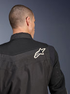 Alpinestars T-Dyno Air Jacket, Black textile motorcycle jacket, close-up back view highlighting the breathable 3D mesh yoke and sleeves, featuring a white and black star logo on the right shoulder.