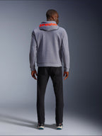 Alpinestars Chrome V2 Sport Hoodie, Gray Heather with Red Fluo accents, Back view showing red Alpinestars branding on the hood, paired with black pants, casual urban riding style with protective tech fleece construction