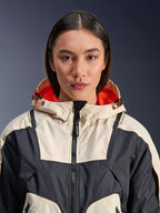 Alpinestars Molly Air Jacket, Women's Textile Motorcycle Jacket, Black Almond, close-up front view of a model wearing the jacket with a cream and black paneled design, bright orange mesh-lined hood, and laser-perforated detailing on the chest