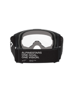 Alpinestars Vision Goggles OTG, óculos de motocross, pretos e cinzentos, vista traseira que mostra uma tira larga tecida preta com o slogan da marca, espuma facial cinzenta de várias camadas, lente transparente, concebidos para um ajuste sobre óculos graduados
