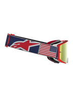 Alpinestars Supertech Fiftyfold, óculos de motocross azuis e vermelhos, lentes espelhadas vermelhas e patch da bandeira EUA.