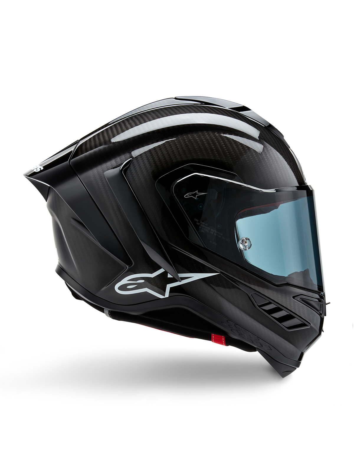 Alpinestars Supertech R10 Solid Helmet, capacete de moto preto com acabamento em fibra de carbono, viseira azul clara, design aerodinâmico com formas angulares, logótipo branco lateral, certificado para corrida