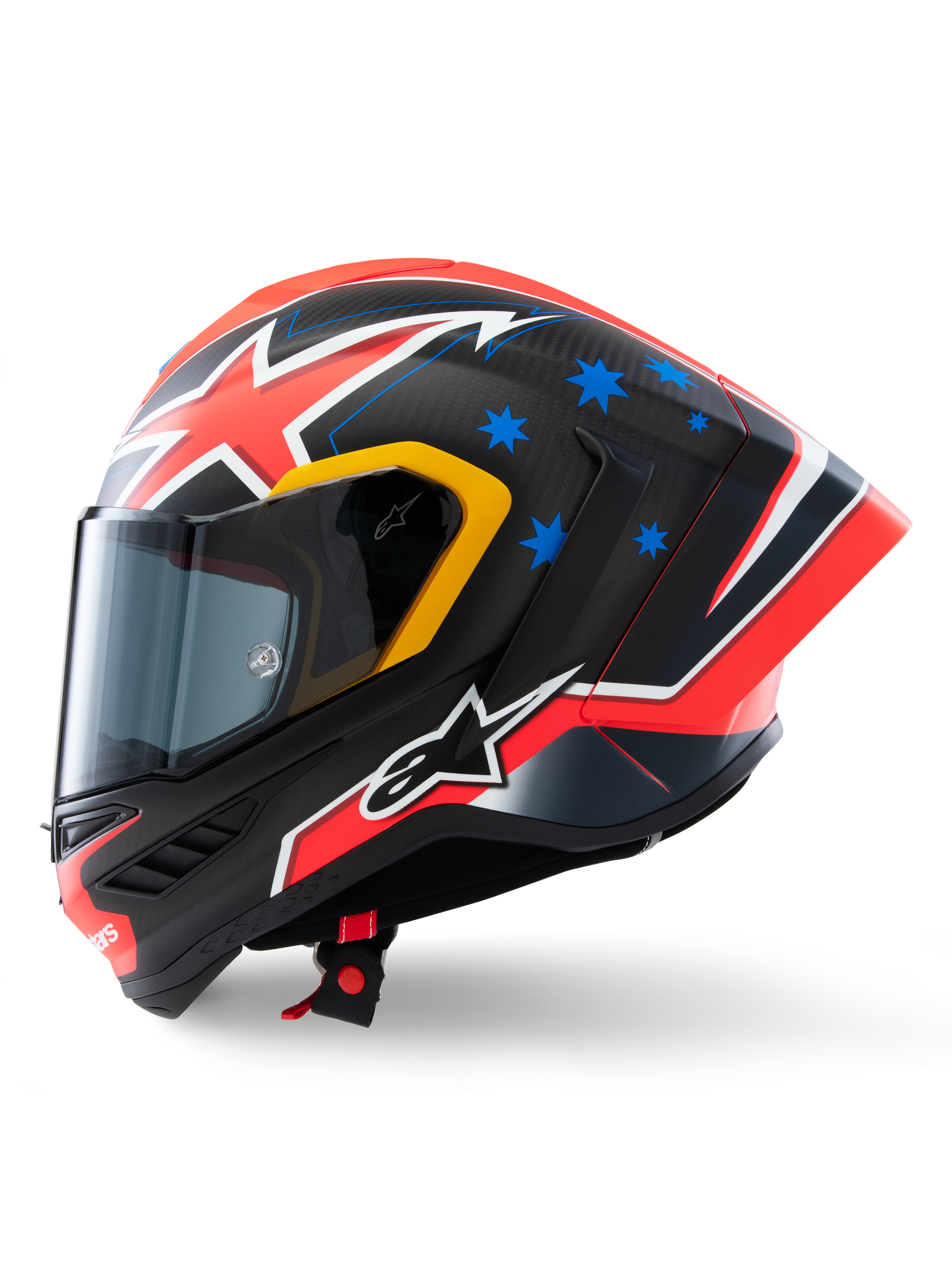 Capacete Alpinestars Supertech R10 Miller Limited Edition, perfil lateral, acabamento Carbon Red Matt com trama de fibra de carbono visível, grafismos de relâmpagos vermelhos e brancos, estrelas azuis na parte traseira, pormenores amarelos em torno da viseira e logótipo Alpinestars branco, capacete de motociclismo de competição de alta performance