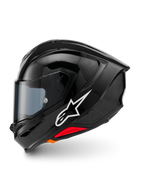 Capacete Alpinestars S-R7 Solid, capacete integral de motociclismo, Preto Brilhante, vista de perfil lateral esquerda com logótipo Alpinestars em branco, calota aerodinâmica com spoiler integrado, viseira fumada e detalhes vermelhos de libertação de emergência.