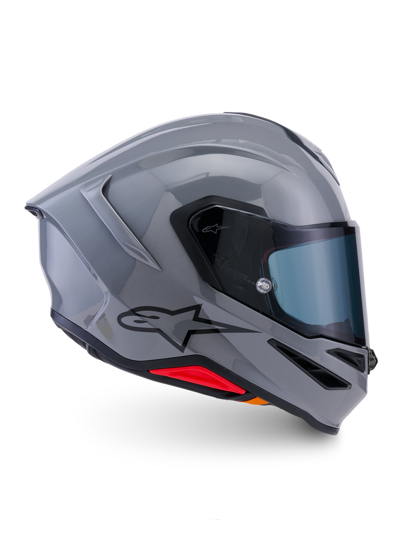 Alpinestars S-R7 Solid Helmet, capacete de motociclismo integral, cinzento brilhante, vista de perfil lateral, calota aerodinâmica em cinzento brilhante com logótipo preto e detalhes vermelhos na base, equipamento de alta performance para competição e condução desportiva