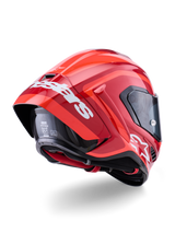 Capacete Alpinestars Supertech R10 Arius, vermelho brilhante com logótipos brancos, vista traseira de três quartos mostrando o spoiler aerodinâmico, construção do casco em fibra de carbono e perfil de corrida elegante com viseira escura