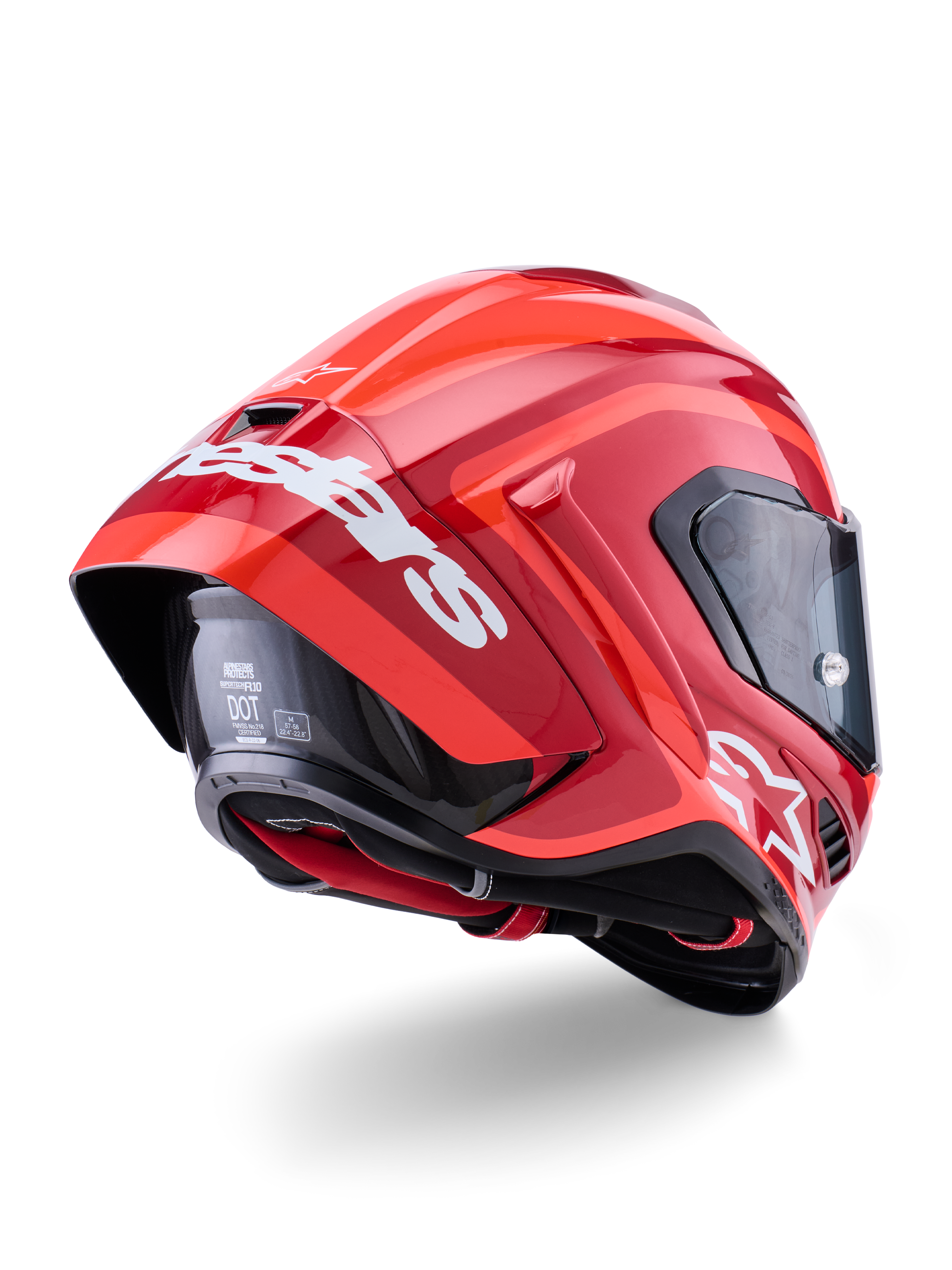 Capacete Alpinestars Supertech R10 Arius, vermelho brilhante com logótipos brancos, vista traseira de três quartos mostrando o spoiler aerodinâmico, construção do casco em fibra de carbono e perfil de corrida elegante com viseira escura