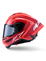 Capacete Alpinestars Supertech R10 Arius, capacete de corrida integral, vermelho brilhante com grafismos de logótipo brancos, vista de perfil lateral destacando o spoiler aerodinâmico e a viseira transparente, calota em composto de fibra de carbono para motociclismo profissional