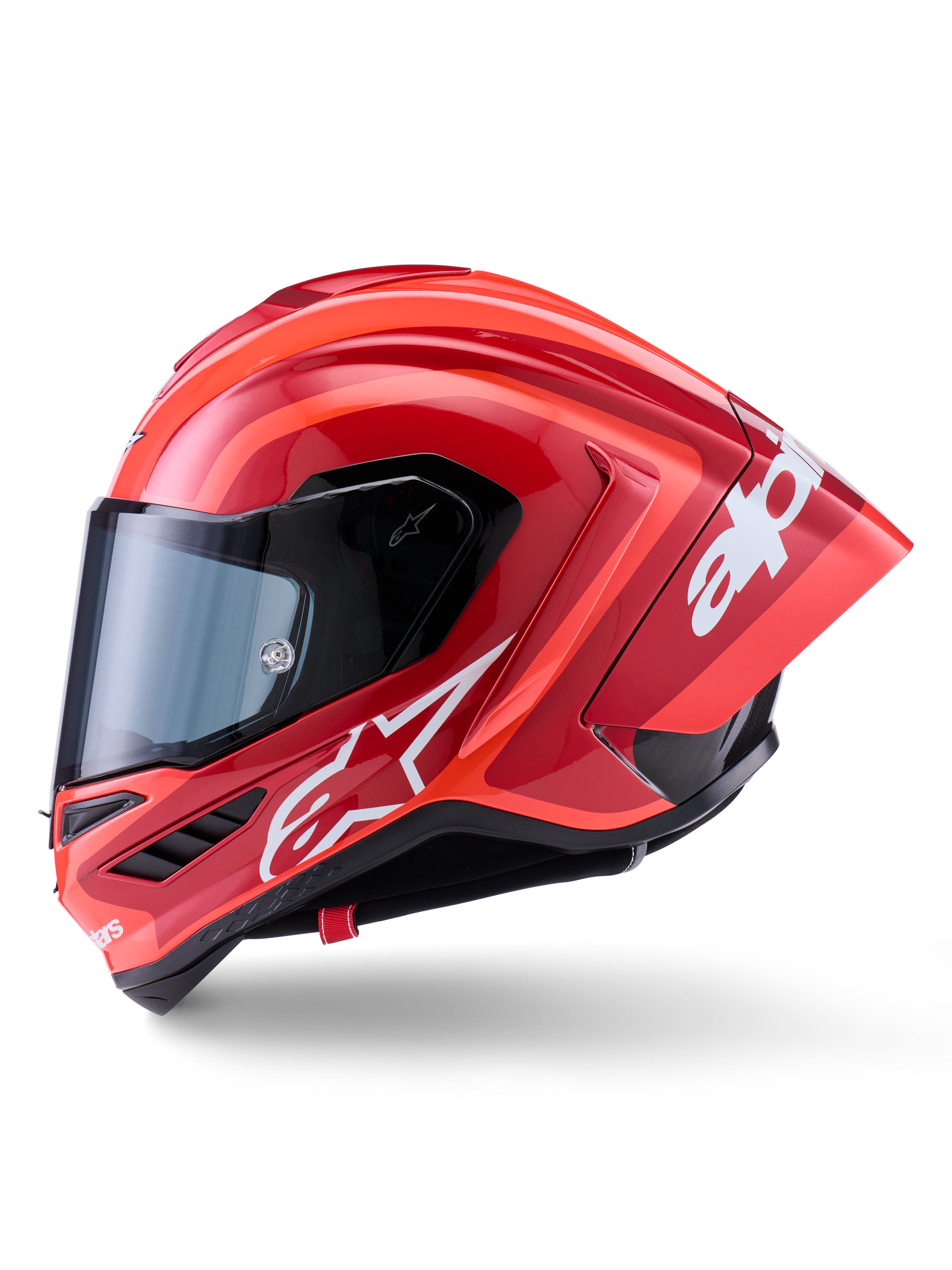 Capacete Alpinestars Supertech R10 Arius, capacete de corrida integral, vermelho brilhante com grafismos de logótipo brancos, vista de perfil lateral destacando o spoiler aerodinâmico e a viseira transparente, calota em composto de fibra de carbono para motociclismo profissional