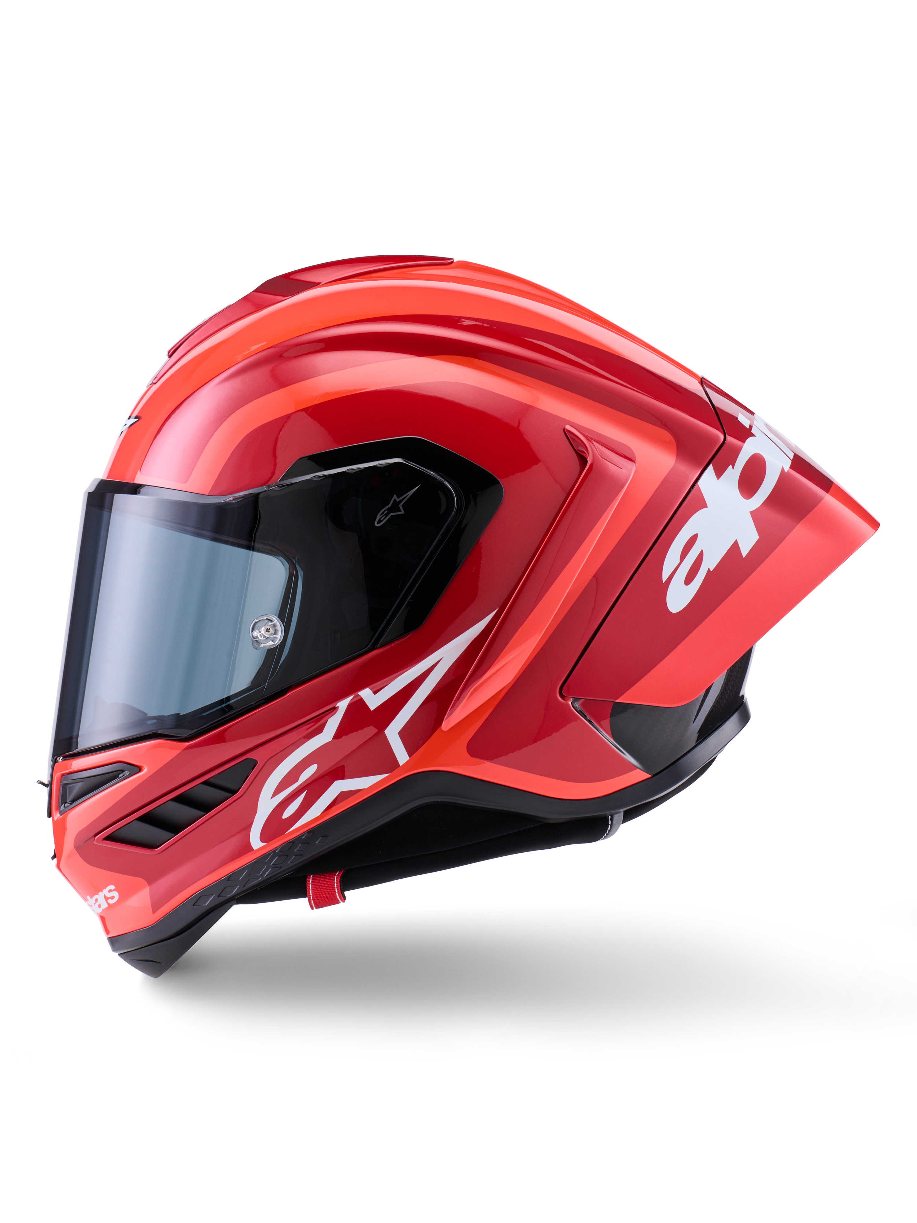Capacete Alpinestars Supertech R10 Arius, capacete de corrida integral, vermelho brilhante com grafismos de logótipo brancos, vista de perfil lateral destacando o spoiler aerodinâmico e a viseira transparente, calota em composto de fibra de carbono para motociclismo profissional