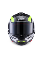 Capacete Alpinestars Supertech R10 Arius, capacete de motociclismo de competição, preto, prateado e amarelo fluorescente brilhante, vista frontal com calota em fibra de carbono, viseira fumada escura e sistema de ventilação integrado