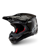 Alpinestars Supertech M10 Solid Helmet ECE 22.06, black glossy carbon motocross helmet with carbon-fiber shell, peak visor and red interior lining, three-quarter view.
