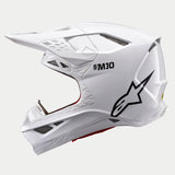 Capacete Alpinestars Supertech M10 Solid, capacete de motocross, branco brilhante, vista de perfil lateral com logótipo Astars preto e marca S-M10, com múltiplas aberturas de ventilação em malha e um design aerodinâmico elegante