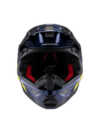 Capacete Alpinestars Supertech M10 TLD Edition 25, capacete de motocross, azul escuro metálico brilhante com forro interior vermelho, vista frontal mostrando malha de ventilação e grafismos laterais em amarelo e laranja, proteção premium para competição off-road