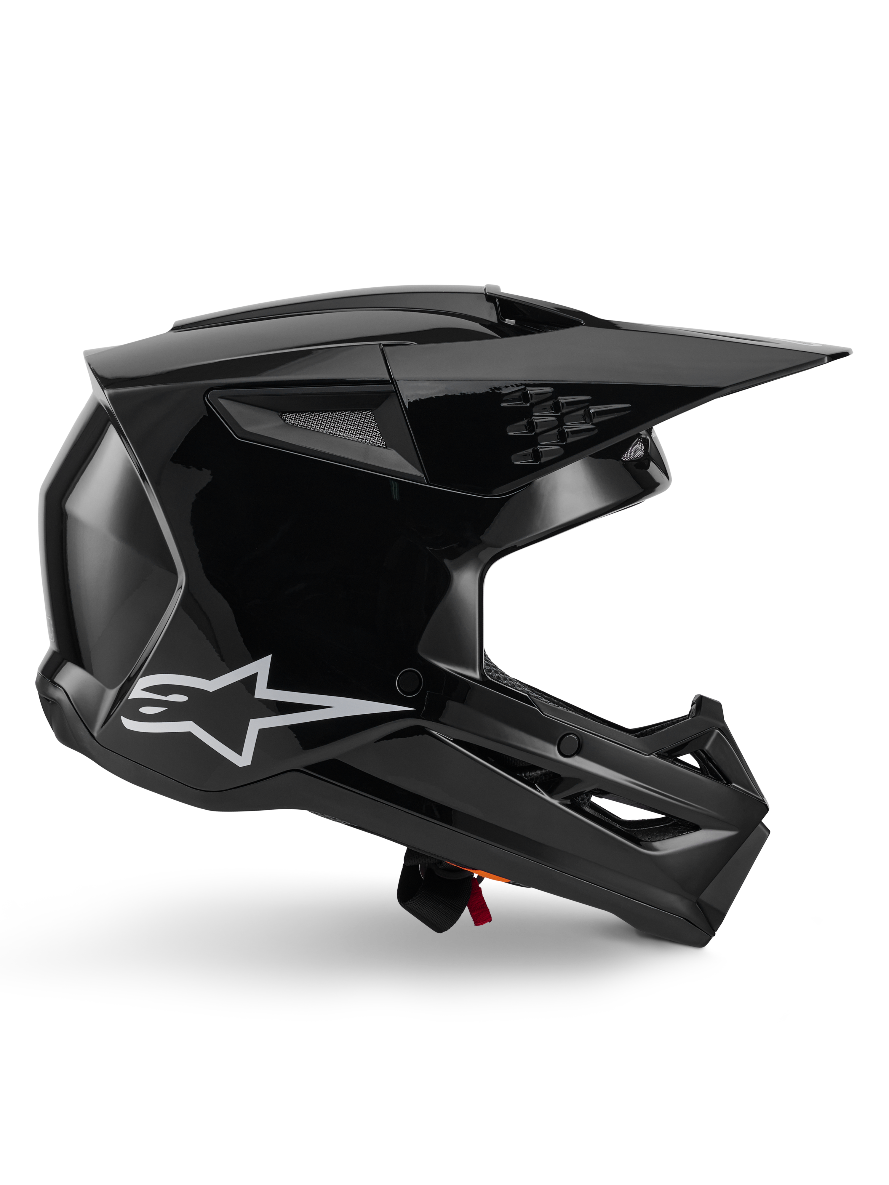 Capacete Alpinestars S-M3 Solid, capacete de motocross, preto brilhante, vista de perfil lateral com logótipo de estrela branca, design aerodinâmico angular com aberturas de ventilação em malha e viseira, equipamento de proteção para corridas todo-o-terreno