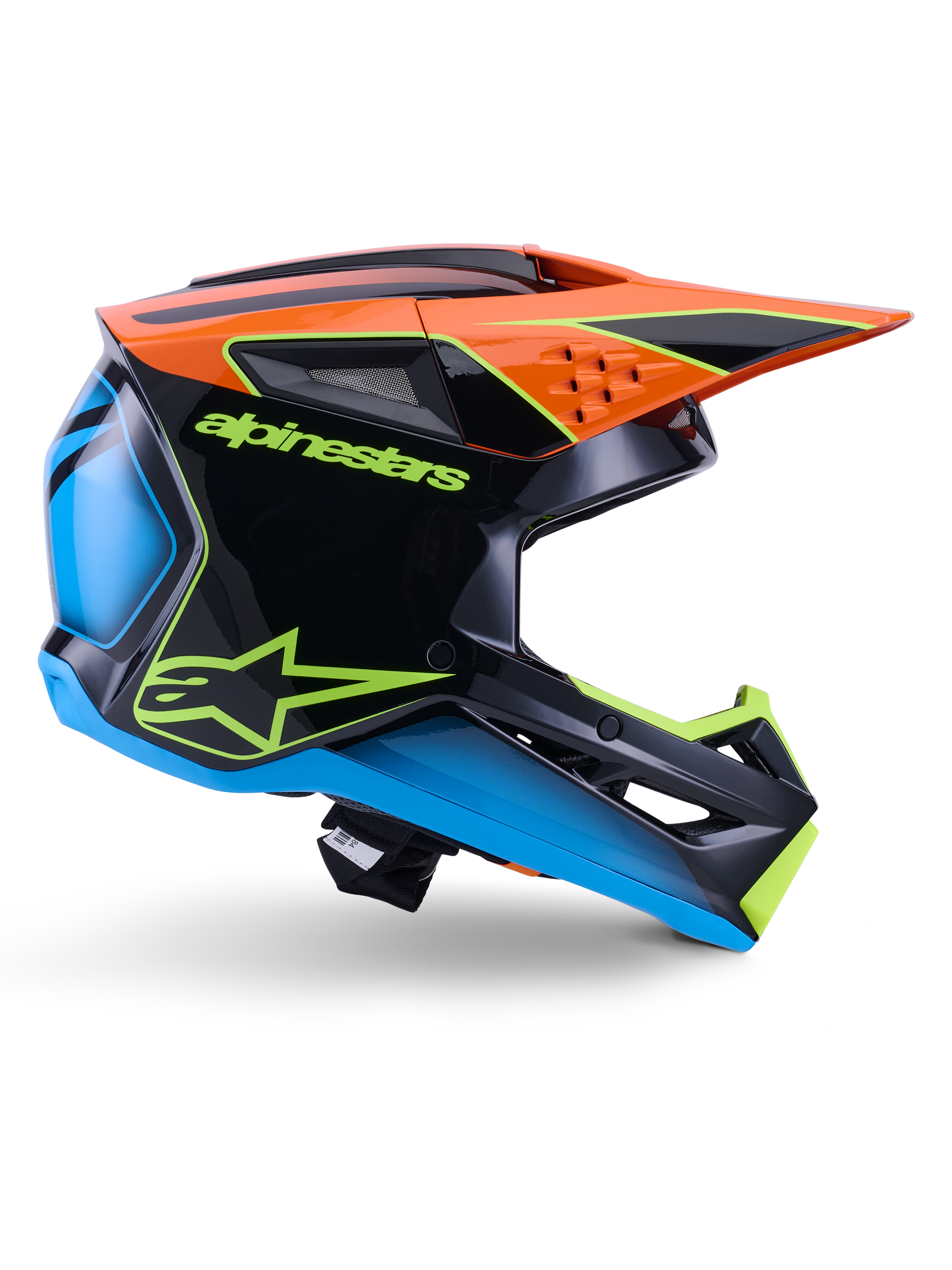Capacete Alpinestars S-M3 Fray ECE 22.06, capacete de motocross, preto, laranja, azul e amarelo néon, perfil lateral de uma calota aerodinâmica brilhante com uma pala laranja proeminente, logótipo em verde néon e detalhes em azul, proteção para competição todo-o-terreno