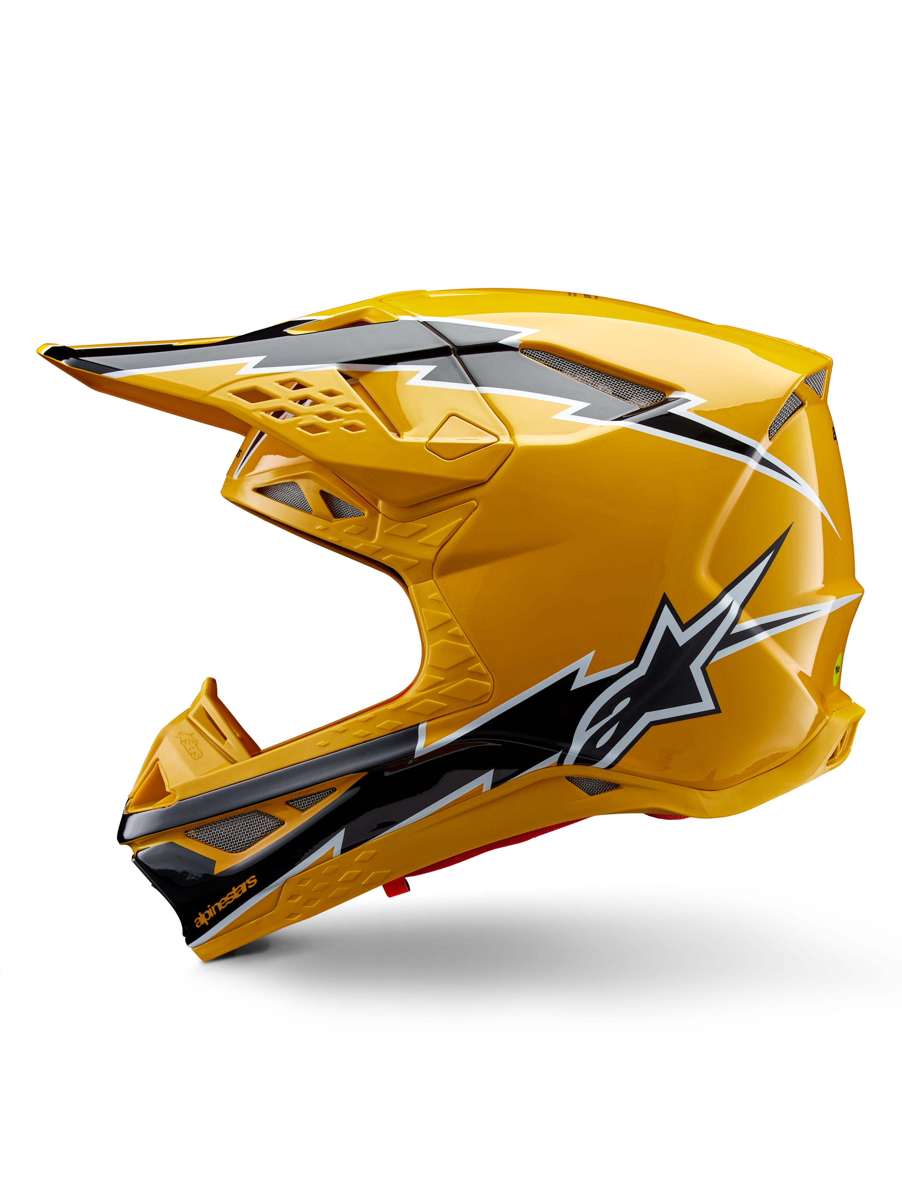 Capacete Alpinestars Supertech M10 Ampress, capacete de motocross, amarelo brilhante com grafismos em preto e branco, vista lateral com designs angulares arrojados, logótipo da estrela Alpinestars e múltiplas aberturas de ventilação com malha prateada, equipamento de corrida profissional para todo-o-terreno