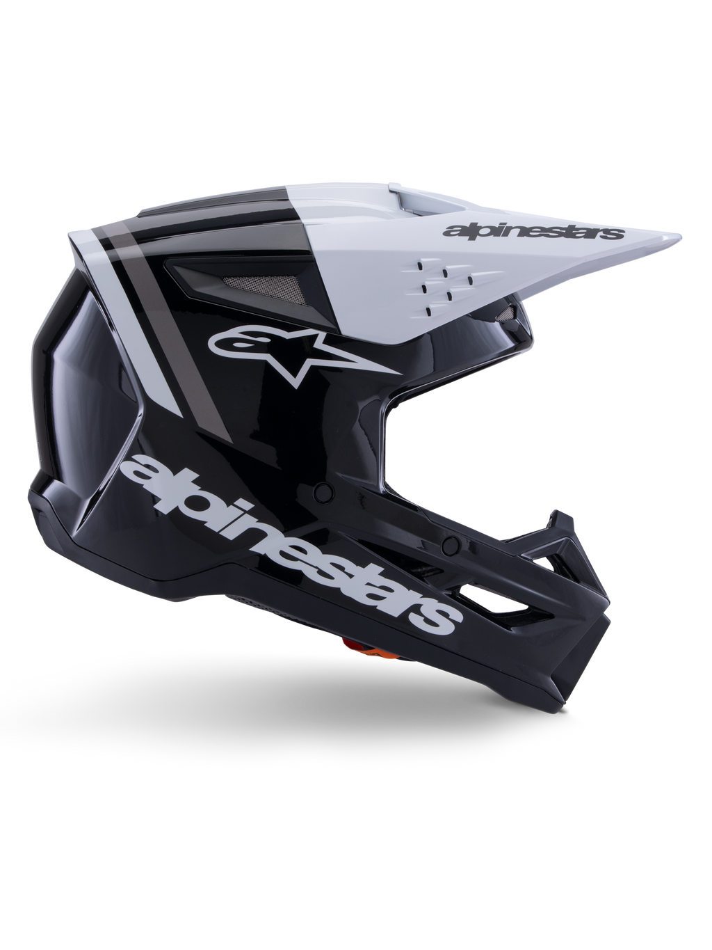 Capacete Alpinestars S-M3 Radium, capacete de motocross off-road, preto, branco e cinzento brilhante, com design aerodinâmico angular e aberturas de ventilação, vista de perfil lateral, acabamento brilhante com riscas cinzentas e viseira branca com logótipo Alpinestars