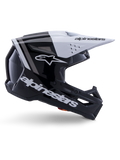 Capacete Alpinestars S-M3 Radium, capacete de motocross off-road, preto, branco e cinzento brilhante, com design aerodinâmico angular e aberturas de ventilação, vista de perfil lateral, acabamento brilhante com riscas cinzentas e viseira branca com logótipo Alpinestars