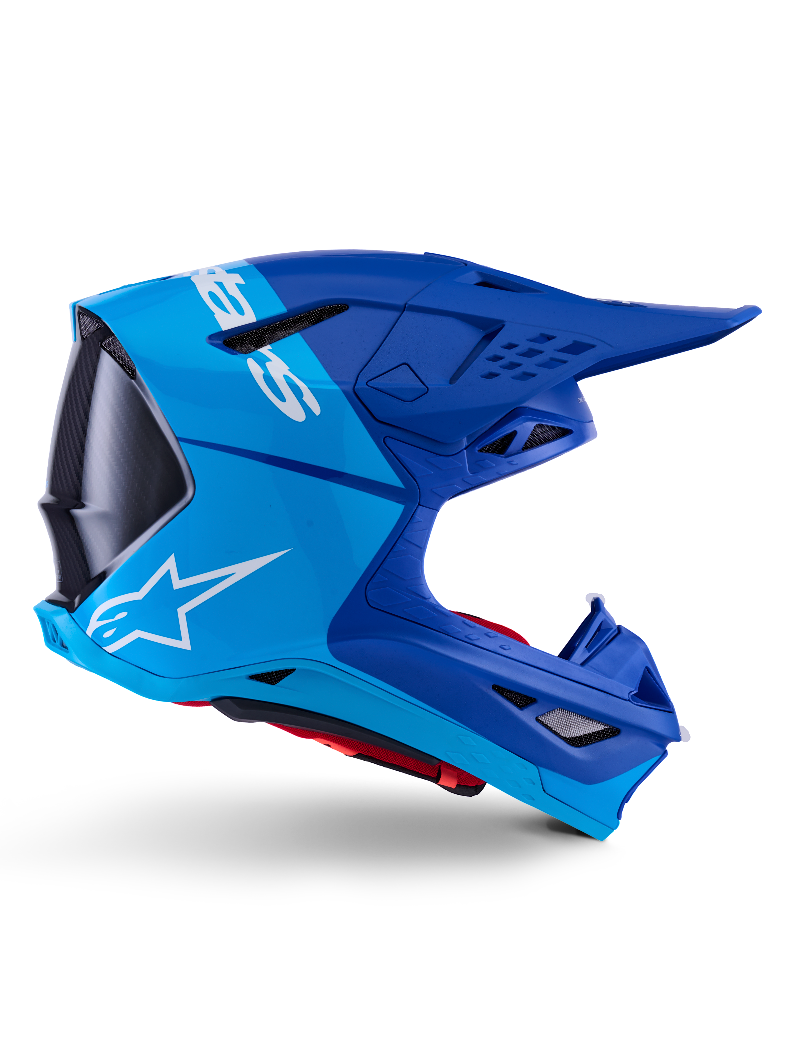 Capacete Alpinestars Supertech M10 Flood, capacete de motocross, azul metálico e azul médio com detalhes em carbono preto, vista de perfil lateral, com logótipo branco, design aerodinâmico com aberturas de ventilação, detalhes de textura em fibra de carbono, proteção profissional para competição off-road