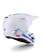 Capacete Alpinestars S-M3 Force OCD, capacete de motocross, branco brilhante com grafismos fluidos em azul e roxo vibrantes, com logótipo Astar prateado e entradas de ventilação laterais, design de calota aerodinâmico para corridas off-road