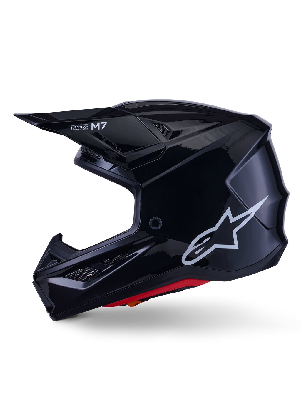 Capacete Alpinestars S-M7 Solid, capacete de motocross em preto brilhante, perfil lateral com logótipo Alpinestars branco, calota aerodinâmica com rede de ventilação e forro interior vermelho, proteção avançada para todo-o-terreno