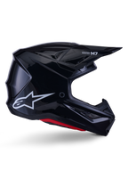 Alpinestars S-M7 Solid Helmet, capacete de motocross, preto brilhante com logótipo de estrela branco e detalhes vermelhos, perfil lateral com design aerodinâmico, entradas de ar em rede angulares e marca Supertech M7 na viseira