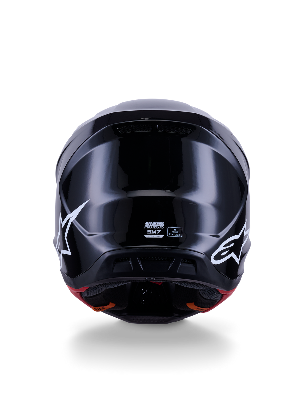 Capacete Alpinestars S-M7 Solid ECE 22.06, capacete de motocross, preto brilhante, vista traseira com logótipos de estrela brancos, calota composta aerodinâmica com acabamento de alto brilho, etiquetas de certificação de segurança e de tamanho no centro