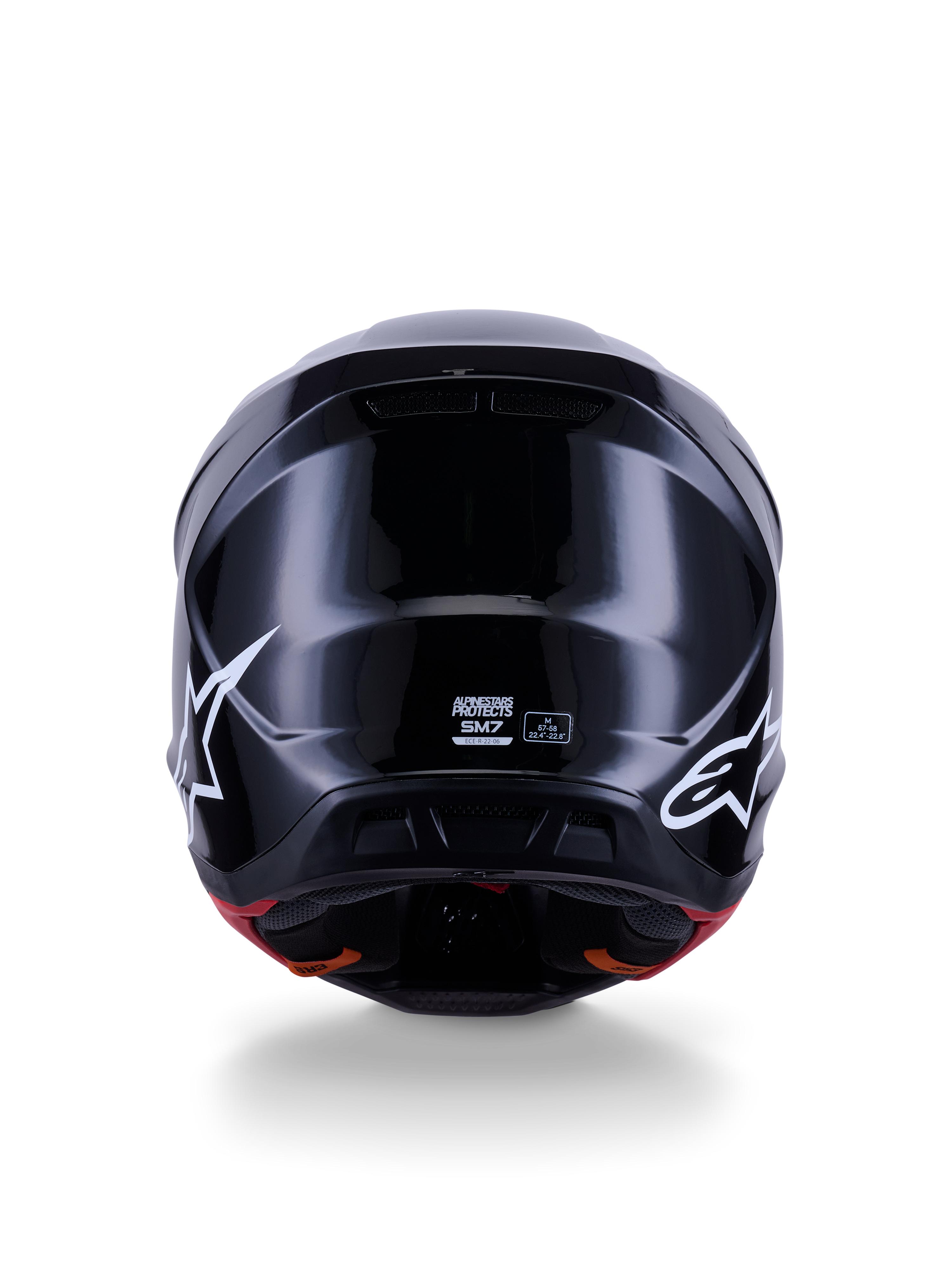 Capacete Alpinestars S-M7 Solid ECE 22.06, capacete de motocross, preto brilhante, vista traseira com logótipos de estrela brancos, calota composta aerodinâmica com acabamento de alto brilho, etiquetas de certificação de segurança e de tamanho no centro