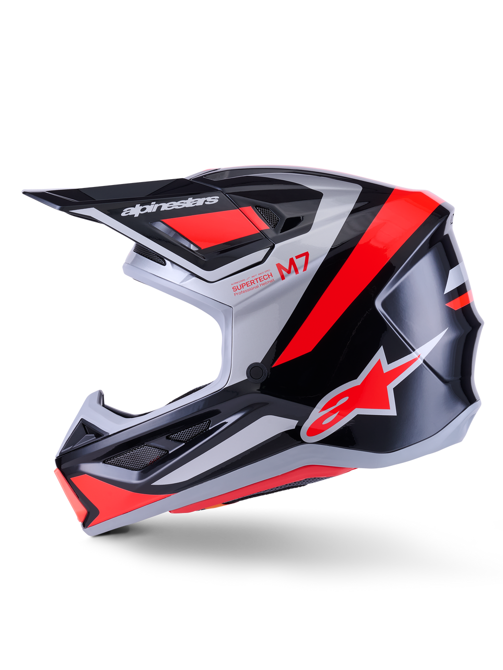 Capacete Alpinestars S-M7 Rise, capacete de motocross, preto, prateado e vermelho fluo brilhante, vista de perfil lateral com calota composta aerodinâmica, proteção de queixo ventilada e pala proeminente com a marca Alpinestars