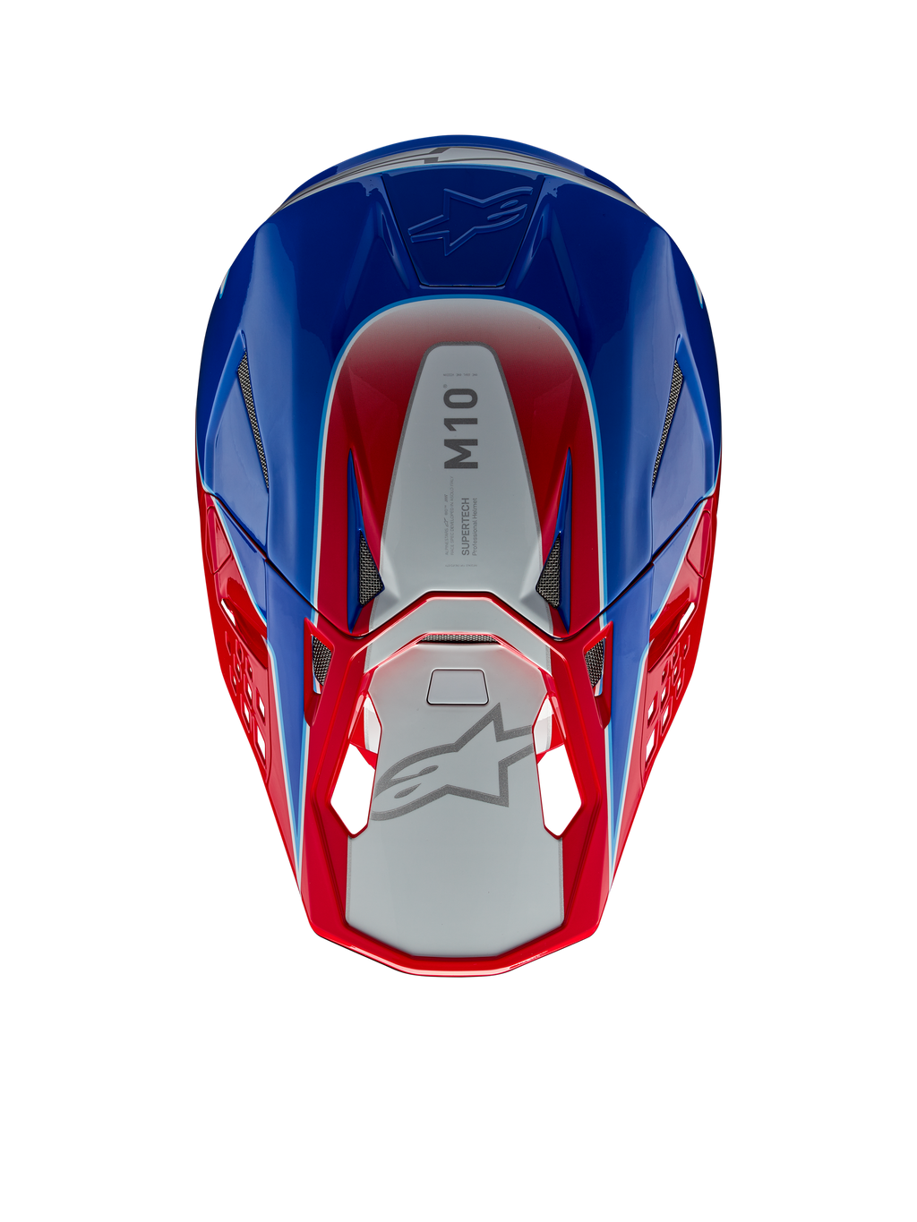 Capacete Alpinestars Supertech M10 Aeon, capacete de motocross, vermelho e azul brilhante, vista superior mostrando o painel central prateado com a marca M10, calota aerodinâmica com detalhes em vermelho e azul, aberturas de ventilação em malha, proteção de cabeça de alta performance para motocross