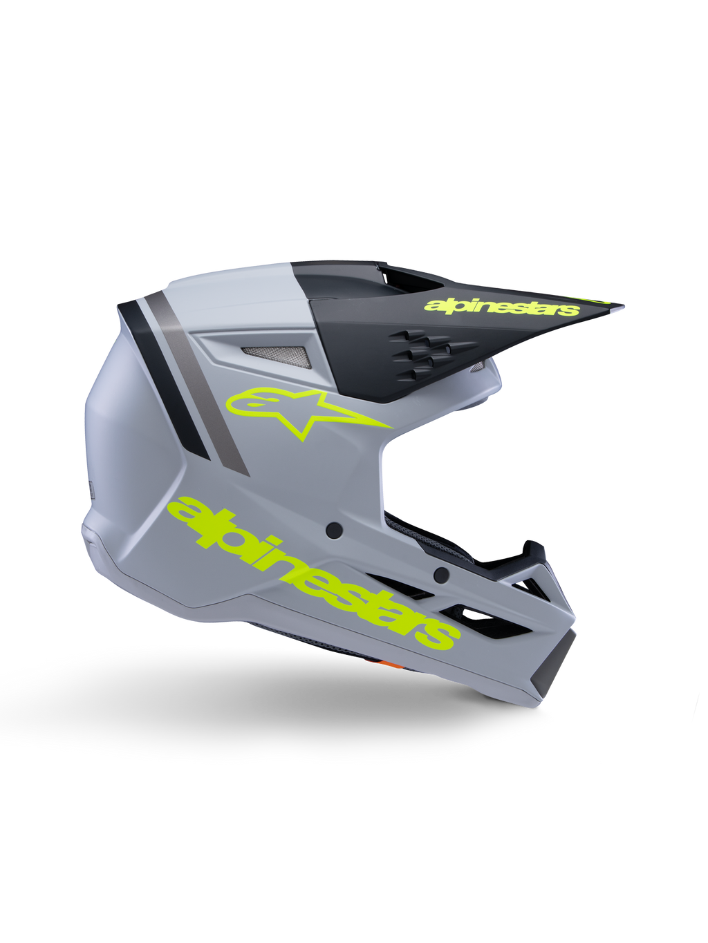 Capacete Alpinestars S-M3 Youth Radium ECE 22.06, capacete de motocross para jovens, cinzento mate e preto com logótipos em amarelo néon, perfil lateral exibindo o logótipo e texto Alpinestars, design aerodinâmico com ventilação integrada e viseira preta.