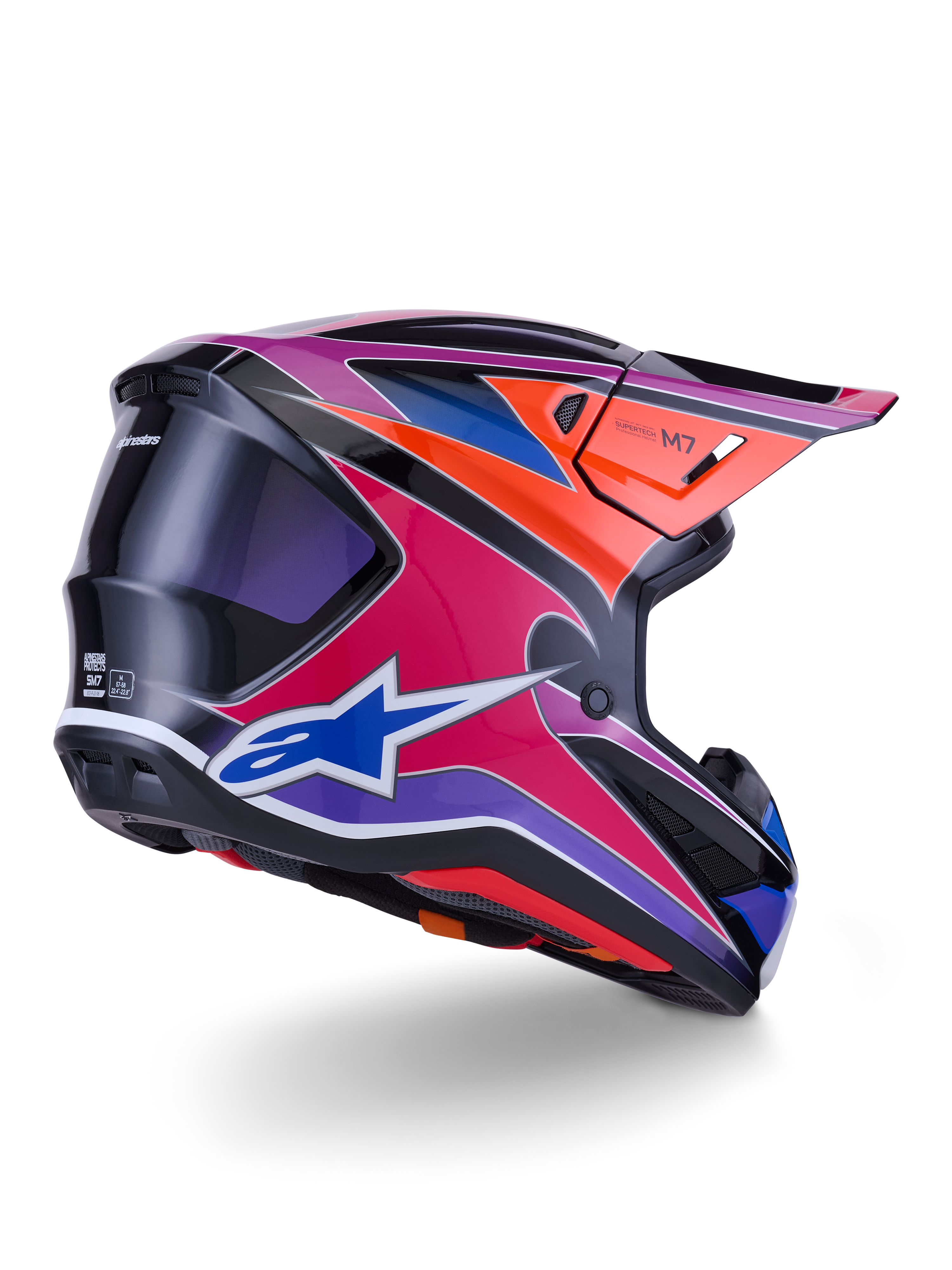 Alpinestars S-M7 Fuse Helmet, Motocross Helmet, Blue Purple and Pink Glossy finish with orange and black accents, rear three-quarter view showing the aerodynamic shell, visor, and ventilation ports, professional off-road racing protection