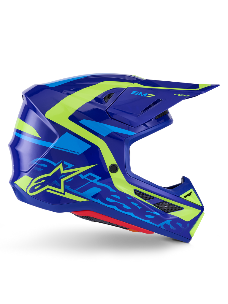 Capacete Alpinestars S-M7 Deed ECE 22.06, capacete de motocross, azul e amarelo néon brilhante, vista de perfil lateral com calota aerodinâmica e logótipo Alpinestars em destaque, detalhes gráficos em amarelo vibrante e azul claro, múltiplas aberturas de ventilação e design de viseira integrada para corridas off-road de elite