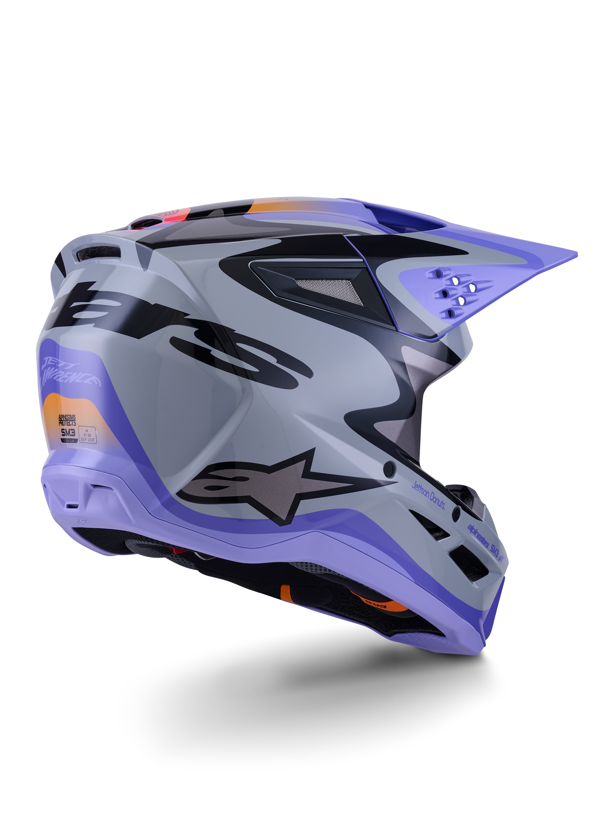Alpinestars S-M3 Jettson Helmet ECE 22.06, capacete de motocross, cinzento, roxo e preto brilhante, vista traseira de três quartos apresentando a calota termo-injetada aerodinâmica com aberturas de ventilação e design gráfico arrojado