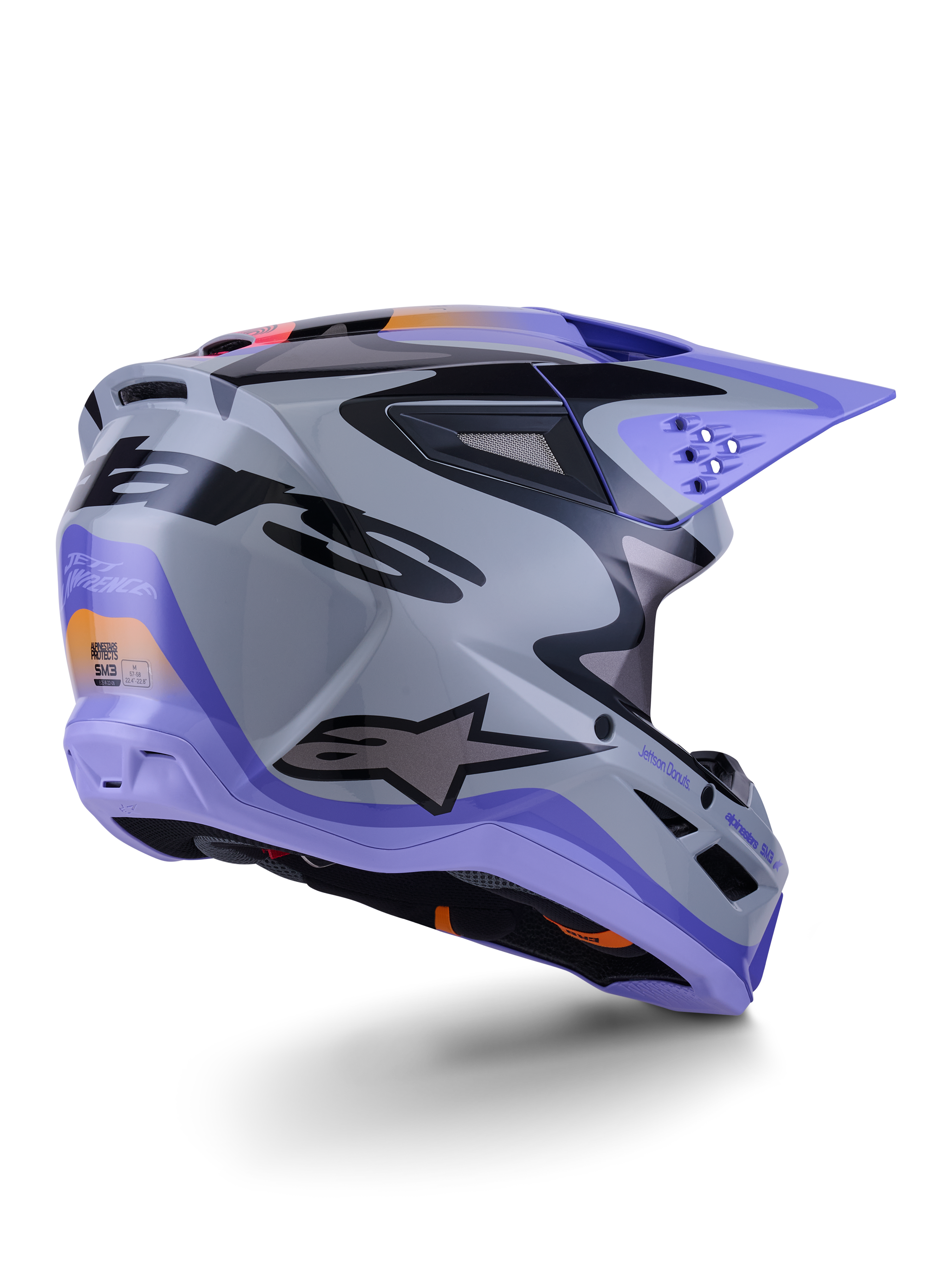 Alpinestars S-M3 Jettson Helmet ECE 22.06, capacete de motocross, cinzento, roxo e preto brilhante, vista traseira de três quartos apresentando a calota termo-injetada aerodinâmica com aberturas de ventilação e design gráfico arrojado