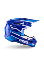 Capacete de Motocross para Jovens Yamaha S-M3, azul e branco brilhante, vista de perfil lateral com marca Yamaha em destaque e logótipo de estrela da Alpinestars, design geométrico com realces em azul claro, calota ventilada com viseira longa, proteção de cabeça para todo-o-terreno com certificação ECE 22.06