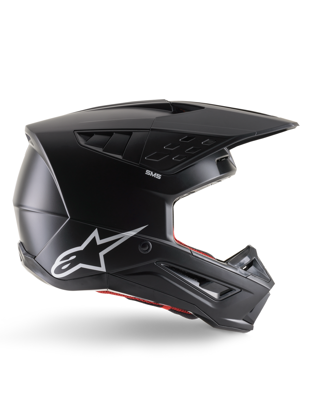 Capacete Alpinestars S-M5 Solid, capacete de motocross, preto mate com logótipo da estrela Alpinestars em branco e forro interior vermelho, design aerodinâmico com várias aberturas de ventilação e viseira longa, proteção todo-o-terreno com certificação ECE 22.06