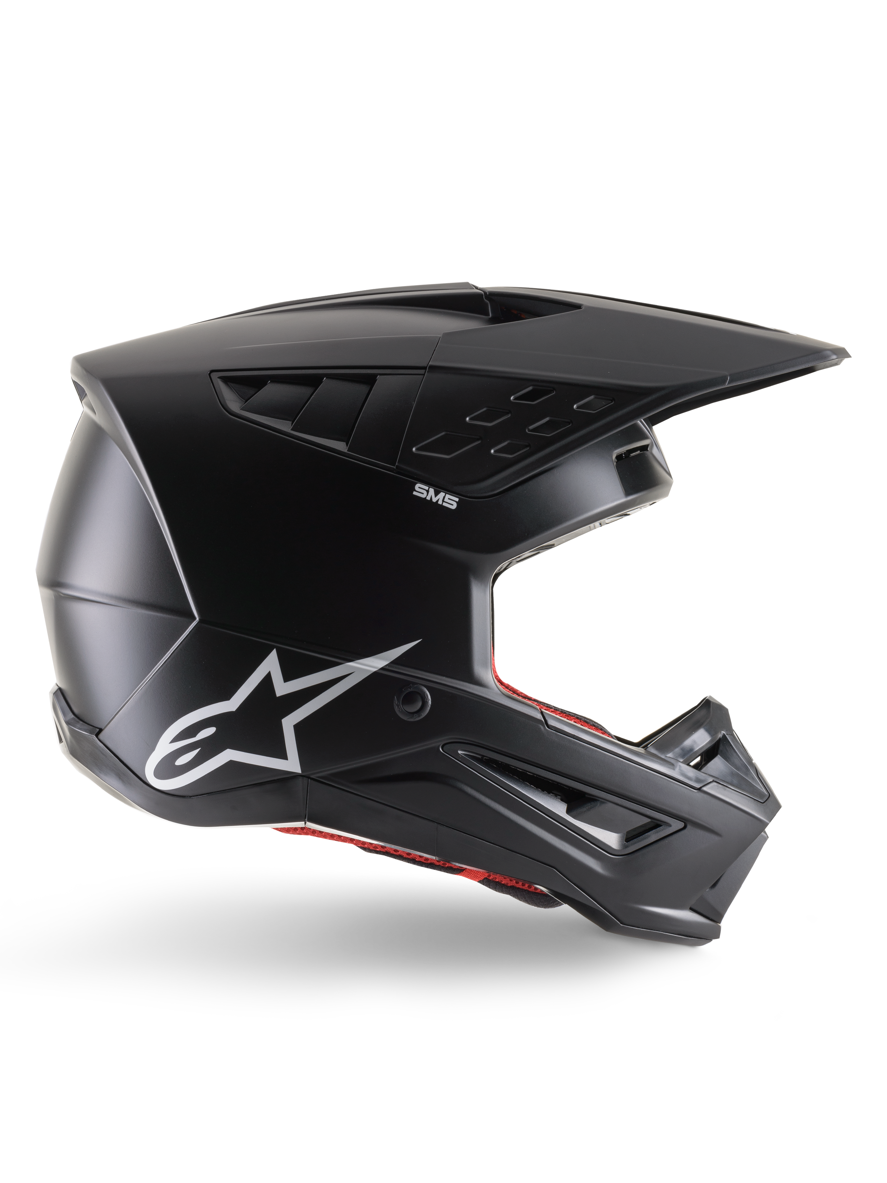 Capacete Alpinestars S-M5 Solid, capacete de motocross, preto mate com logótipo da estrela Alpinestars em branco e forro interior vermelho, design aerodinâmico com várias aberturas de ventilação e viseira longa, proteção todo-o-terreno com certificação ECE 22.06