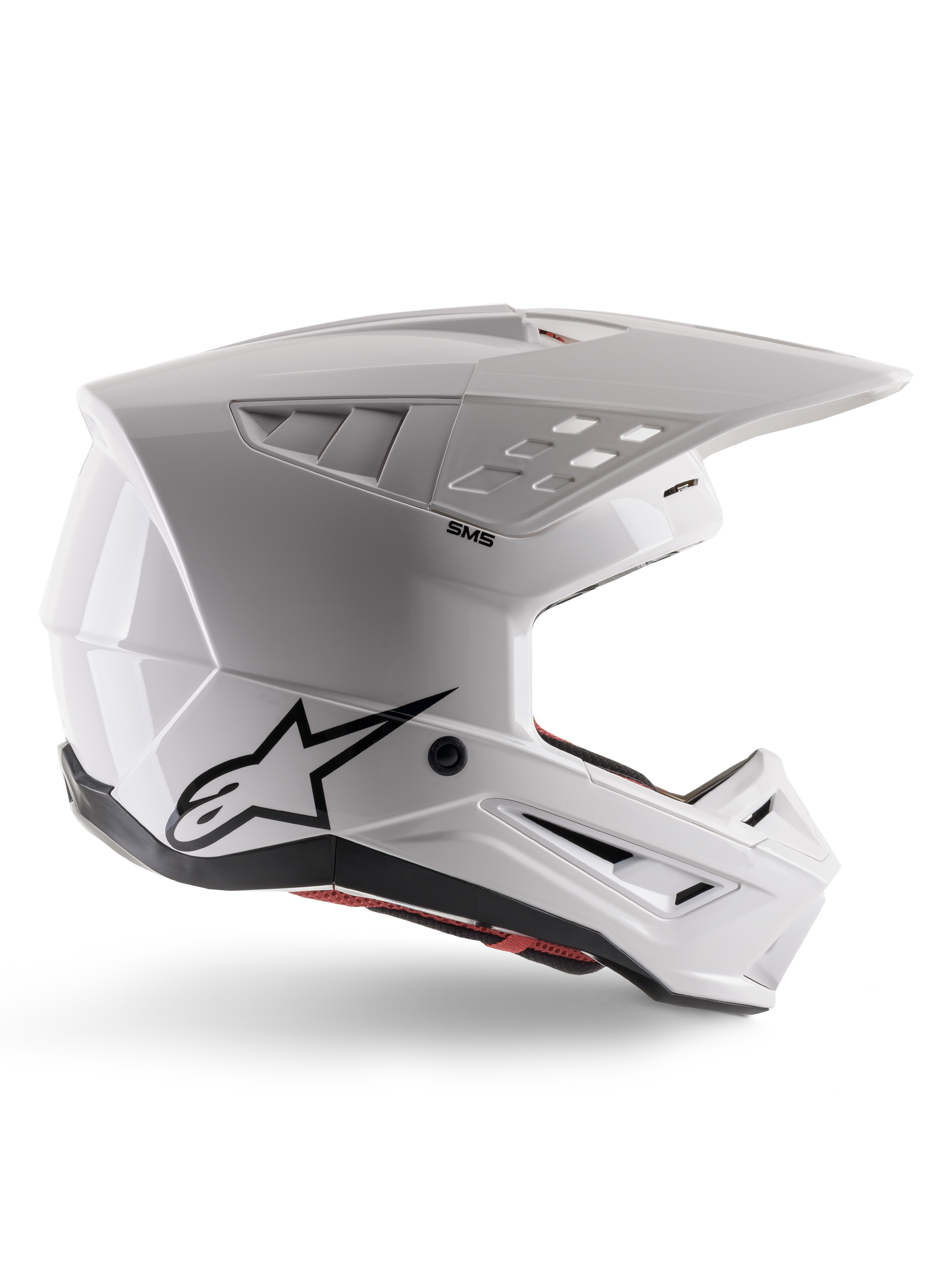 Alpinestars S-M5 Solid Helmet ECE 22.06, capacete de motocross, branco brilhante, perfil lateral com design aerodinâmico angular, viseira proeminente, entradas de ar integradas, logótipo Astars preto na parte traseira e acolchoamento interior vermelho visível