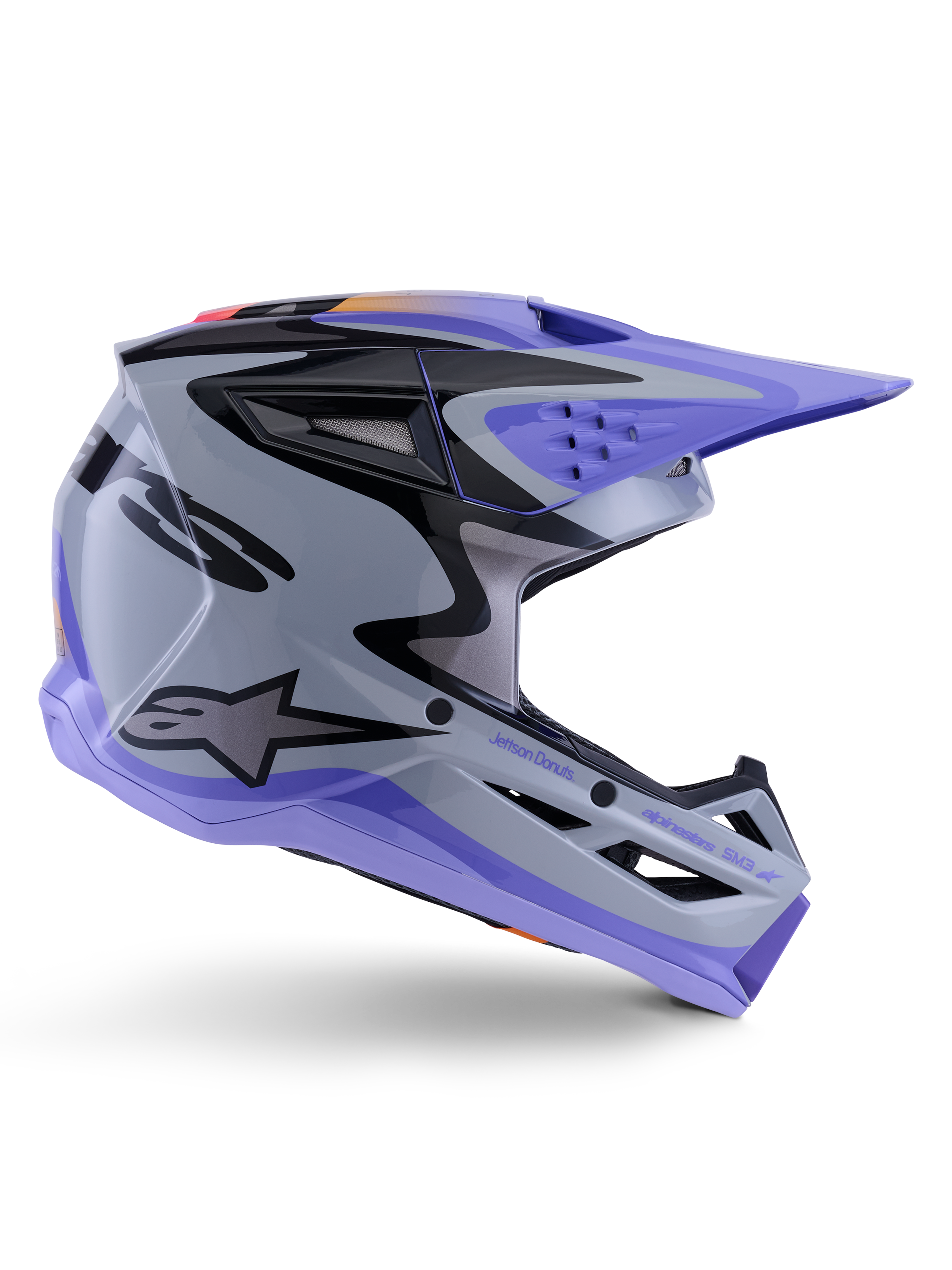 Alpinestars S-M3 Jettson Helmet ECE 22.06, capacete de motocross, cinzento, roxo e preto brilhante, vista de perfil com viseira e queixeira roxas, calota aerodinâmica elegante com gráficos pretos, múltiplas aberturas de ventilação e marca "Jettson Donuts" na lateral.