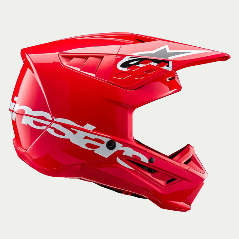 Alpinestars S-M5 Corp Helmet ECE, capacete de motocross, vermelho brilhante, vista lateral de perfil exibindo um logótipo Alpinestars branco grande na parte inferior da calota, viseira aerodinâmica ventilada com logótipo de estrela e acabamento de alto brilho para proteção em corridas todo-o-terreno