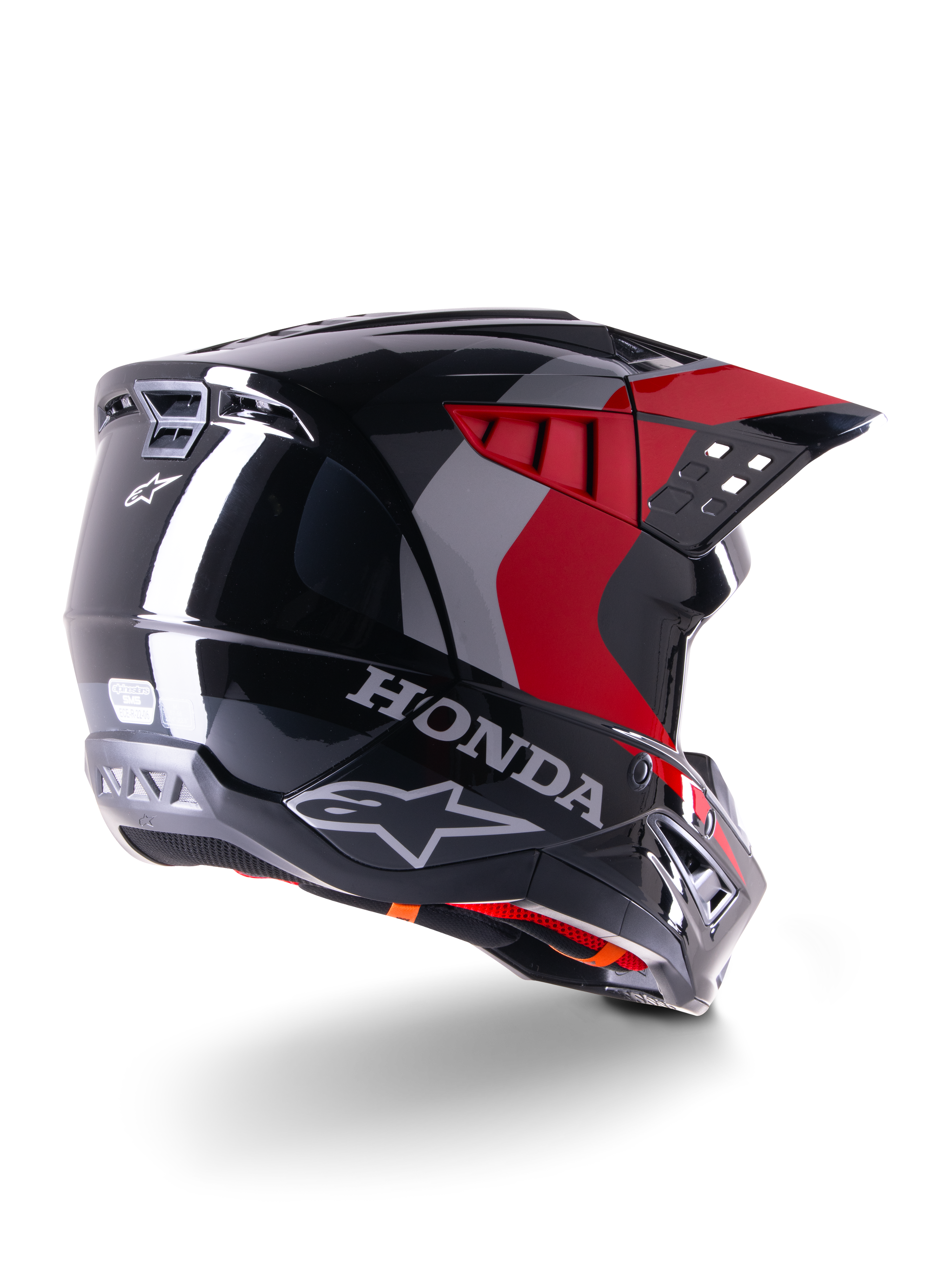 Alpinestars Honda S-M5 Helmet ECE, capacete de motocross, preto e vermelho brilhante, vista traseira de três quartos com marca Honda e logótipos Alpinestars, acabamento brilhante com detalhes gráficos vermelhos e cinzentos, concebido para proteção em todo-o-terreno