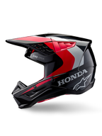 Capacete Alpinestars Honda S-M5, capacete de motocross, preto, vermelho e prateado brilhante, vista de perfil lateral com marca Honda e logótipo da estrela Alpinestars, design elegante com pala integrada e aberturas de ventilação para performance todo-o-terreno